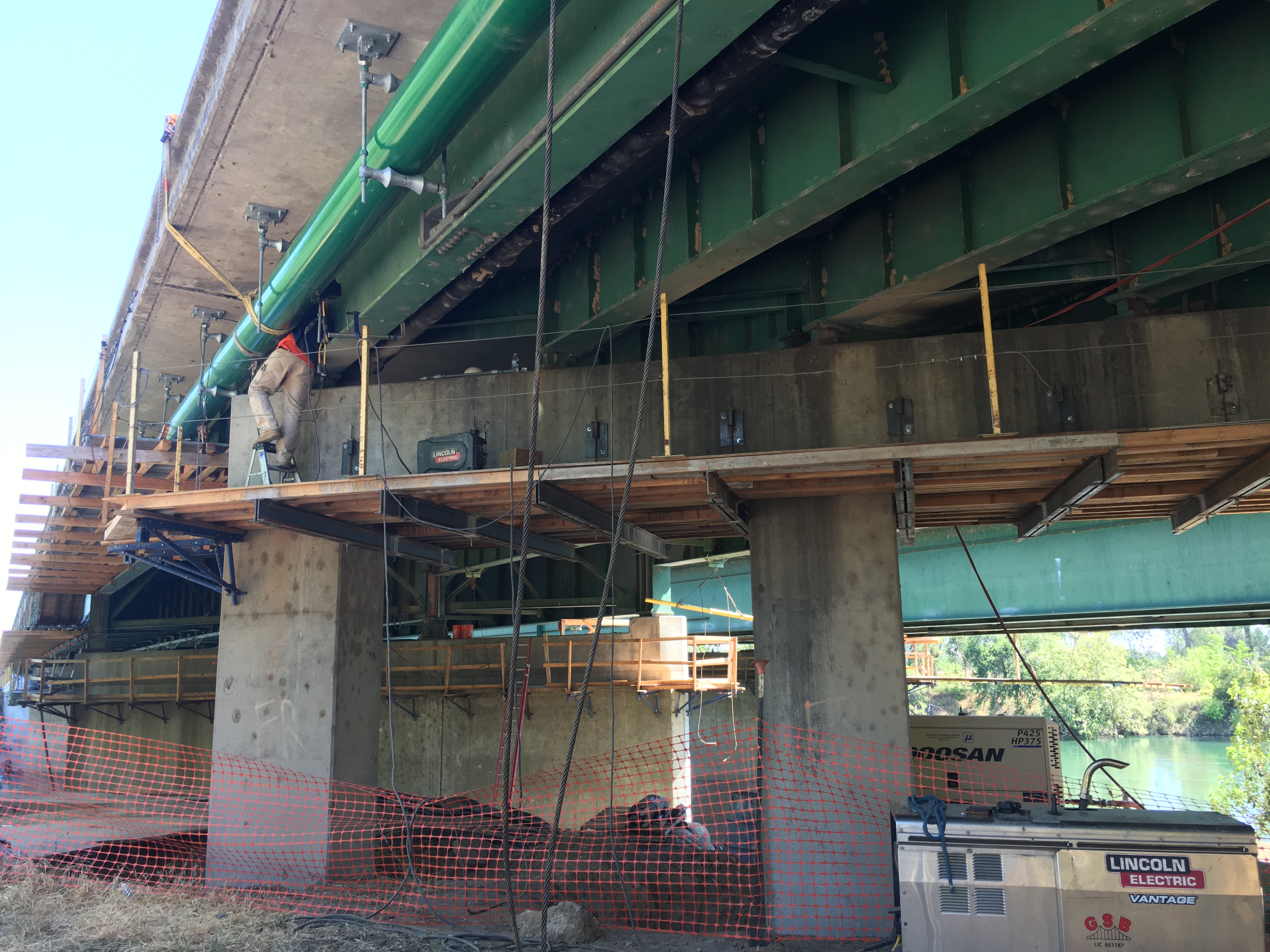 Photo of a worker working under an overpass