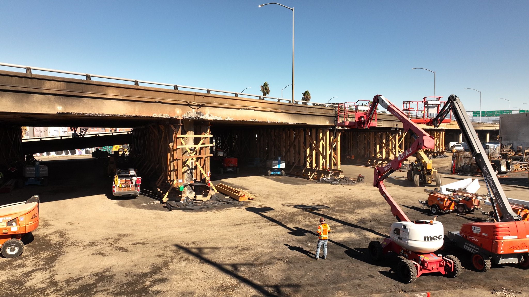 Photo of workers and heavy equipment working on a new bridge