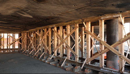A photo taken on Nov 21, 2023, from below a section of Interstate 10 at Alameda Street in Downtown Los Angeles. Wooden supports are shoring up the concrete infrastructure and burn marks are visible from the Nov 11 fire.