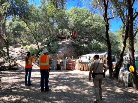 Photo of Caltrans workers at encampment