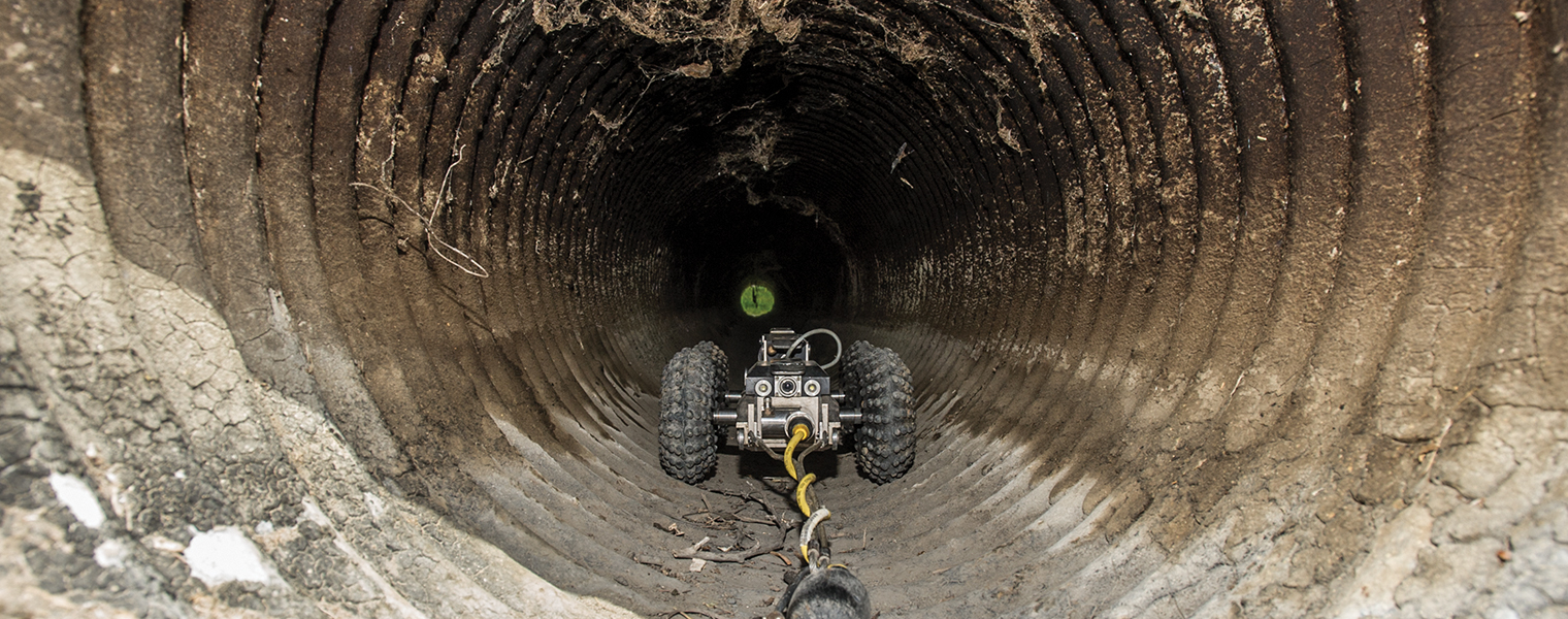 A small robot enters the culvert for inspection
