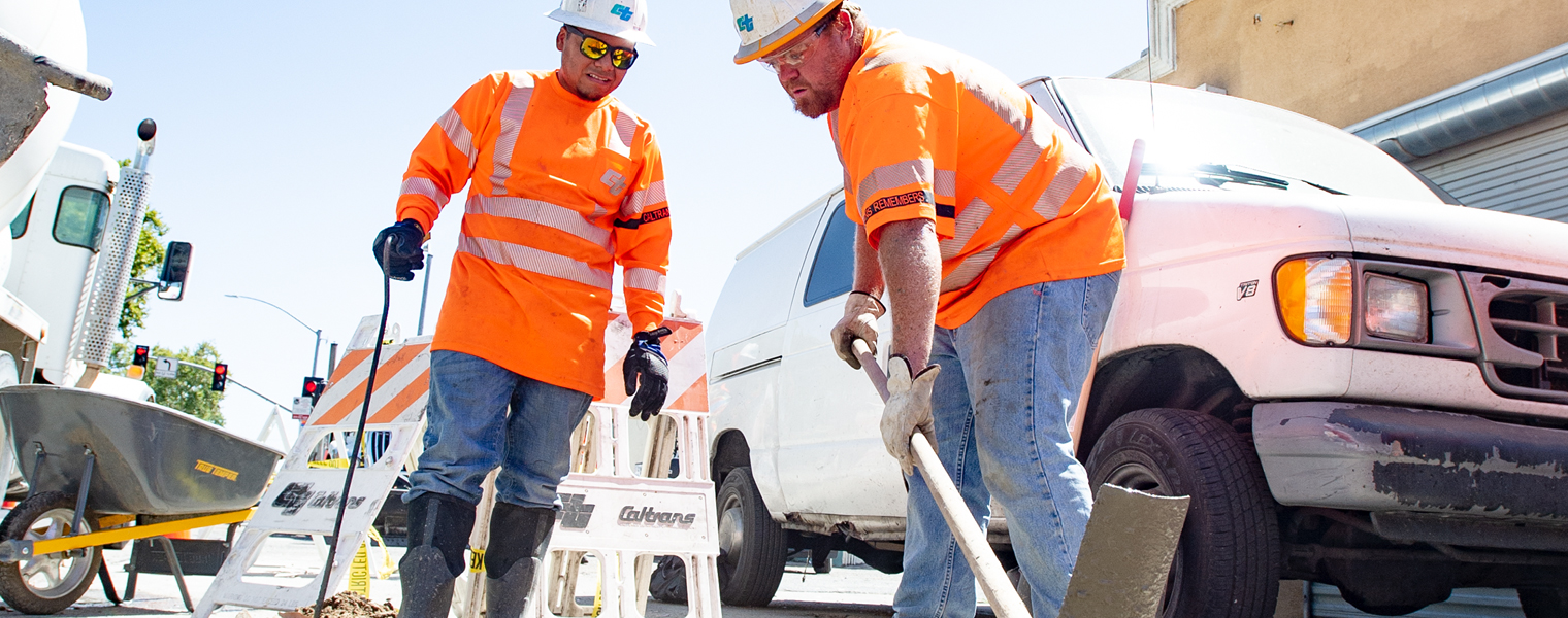 Photo of two Caltrans workers making concrete repairs