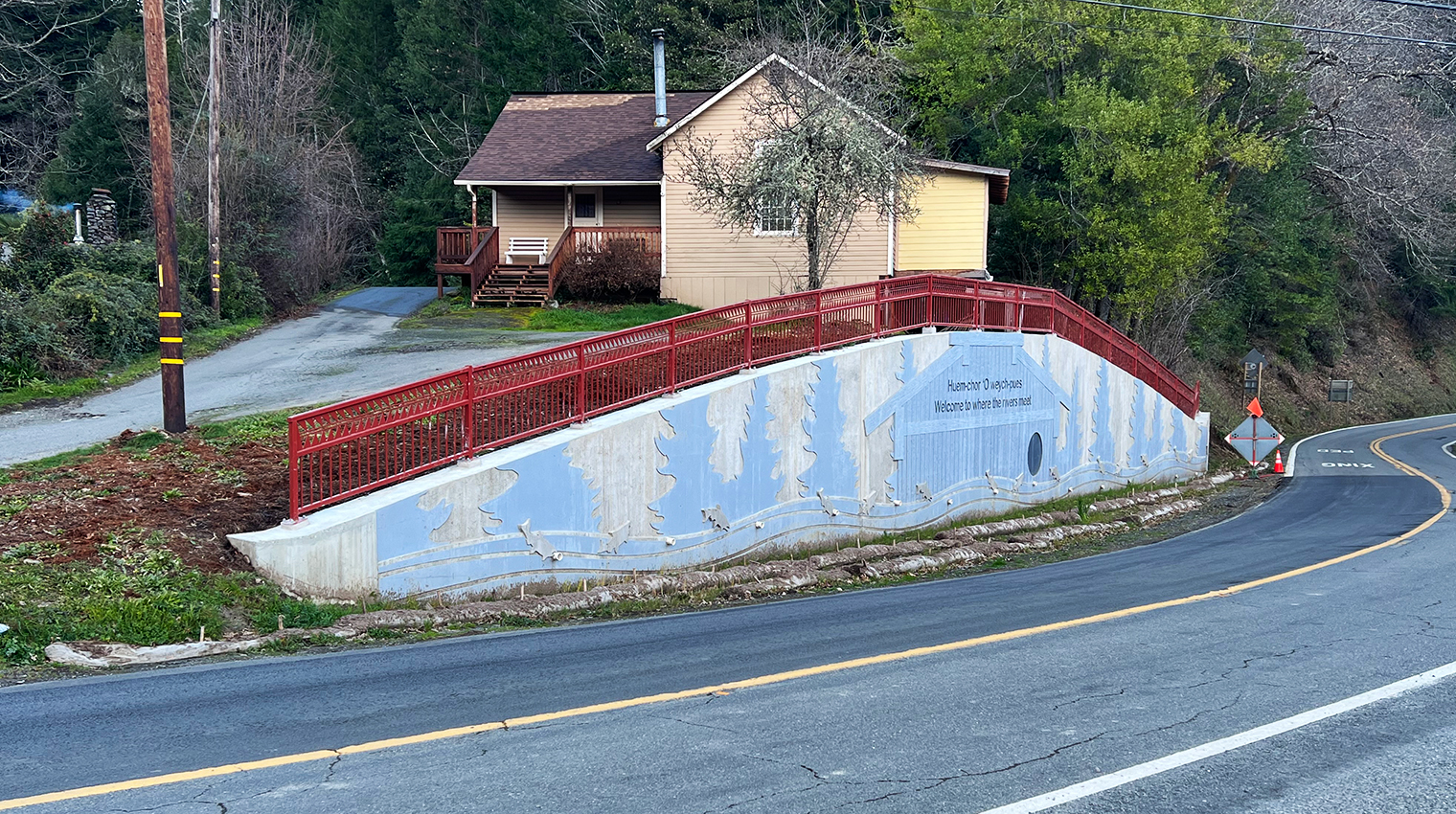 Photo of a tribal heritage monument along a roadway.