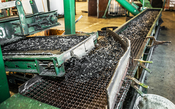 Photo showing bits of rubber being processed on a conveyor belt
