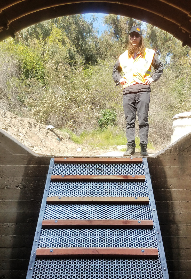 Photo looking up a ramp with a Caltrans employee at the top.