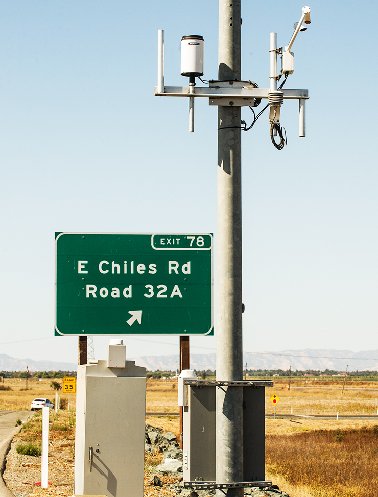 Photo showing TMS elements along the highway, depicting a control box and camera equipment.