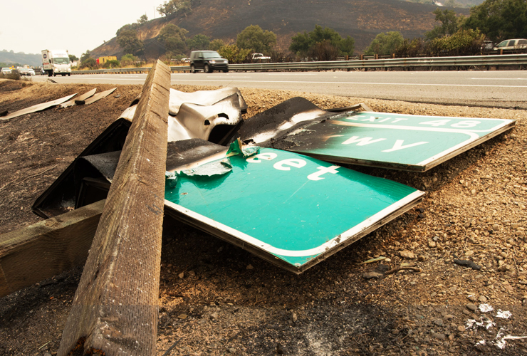 Photo of damaged and fallen road signs along Interstate 80 after the Lightning Complex Fire.