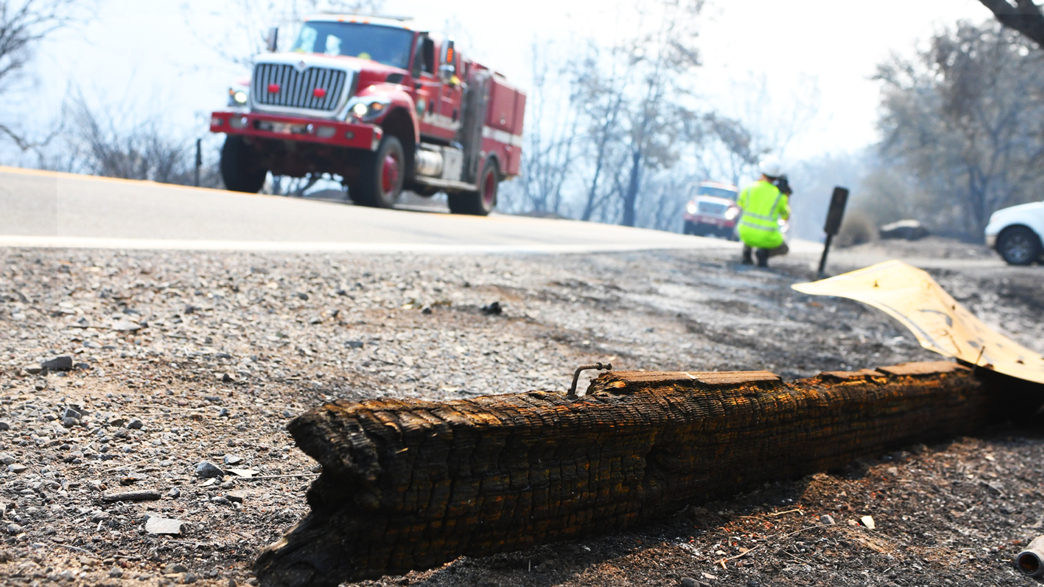 Photo of a highway, fallen sign and fire truck along highway 128 during the Napa fire in August 2020.
