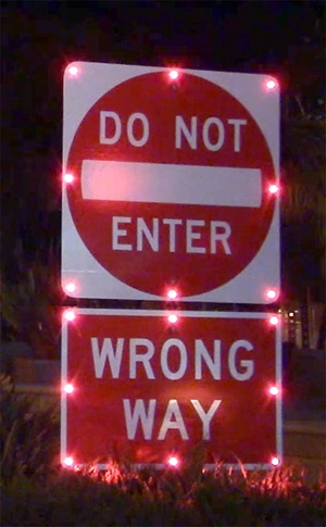 Wrong way signs equipped with 24-hour flashing LED lights warn drivers not to enter the exit ramp
