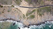 After - California Highway 1 at Rat Creek near Big Sur: aerial view of the project's 150 feet of rebuilt road and new drainage system above the rocky coastline of the Pacific Ocean. 