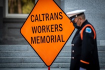 Caltrans Honor Guard member in front of an orange "Caltrans Workers Memorial" sign - 31st Annual Caltrans Workers Memorial Ceremony April 29, 2021 - California State Capitol, Sacramento