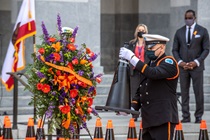 Caltrans Honor Guard member places a black cone in front of a ceremonial wreath in tribute to all fallen highway workers as Caltrans Assistant Deputy of Public Affairs Tamie McGowen and Caltrans Director Toks Omishakin watch from the background - 31st Annual Caltrans Workers Memorial Ceremony April 29, 2021 - California State Capitol, Sacramento