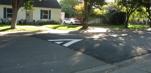Image of a speed hump an elongated mound in the roadway pavement surface extending across the travel way at a right angle to the traffic flow
