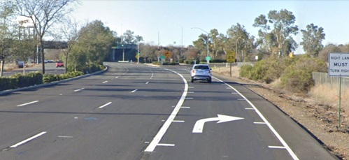 Image of car in a traveled roadway with speed reduction markings, transverse pavement markings placed with progressively reduced spacing to create the perception of increased speed
