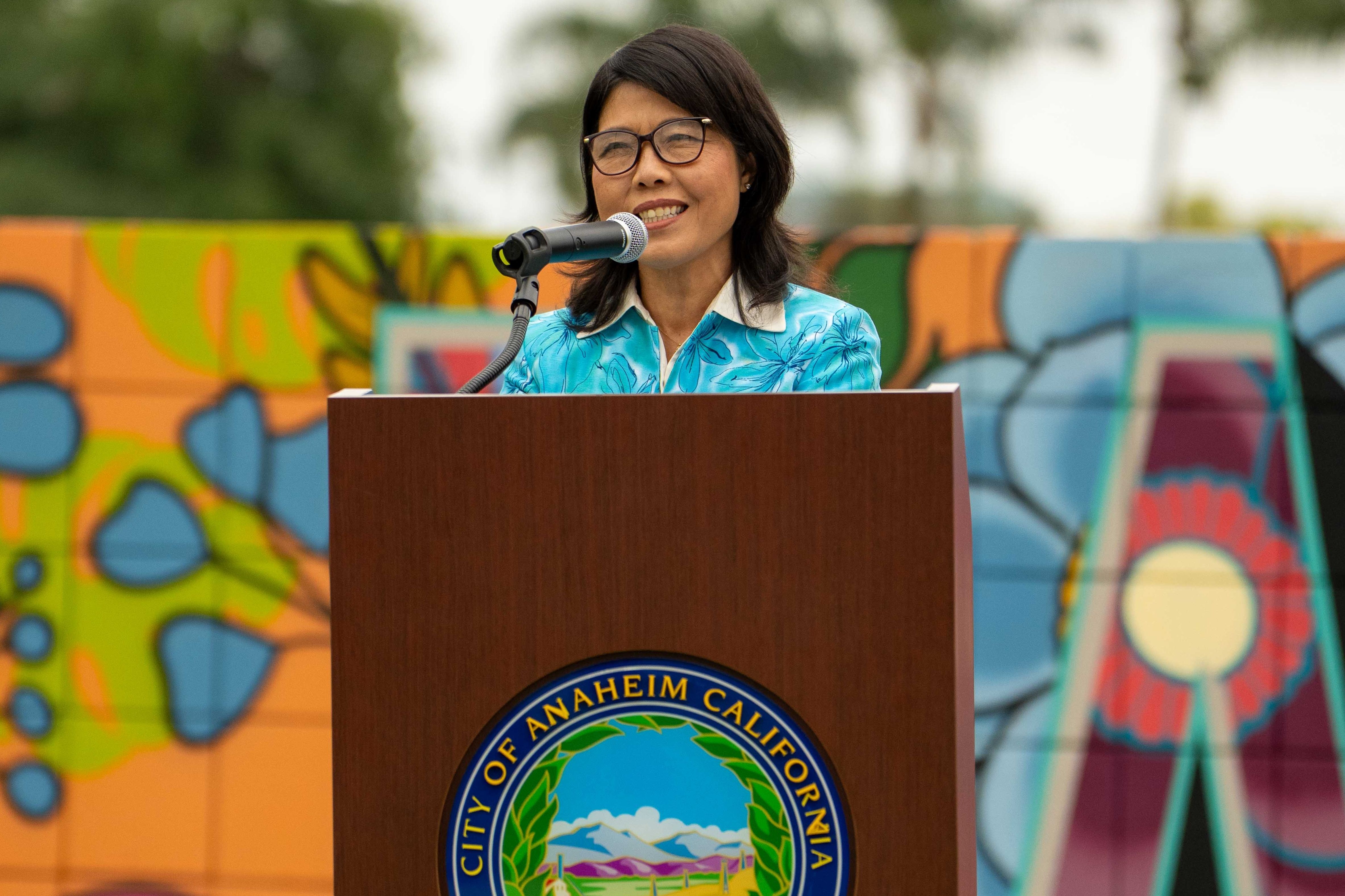 Lan Zhou smiling at the podium